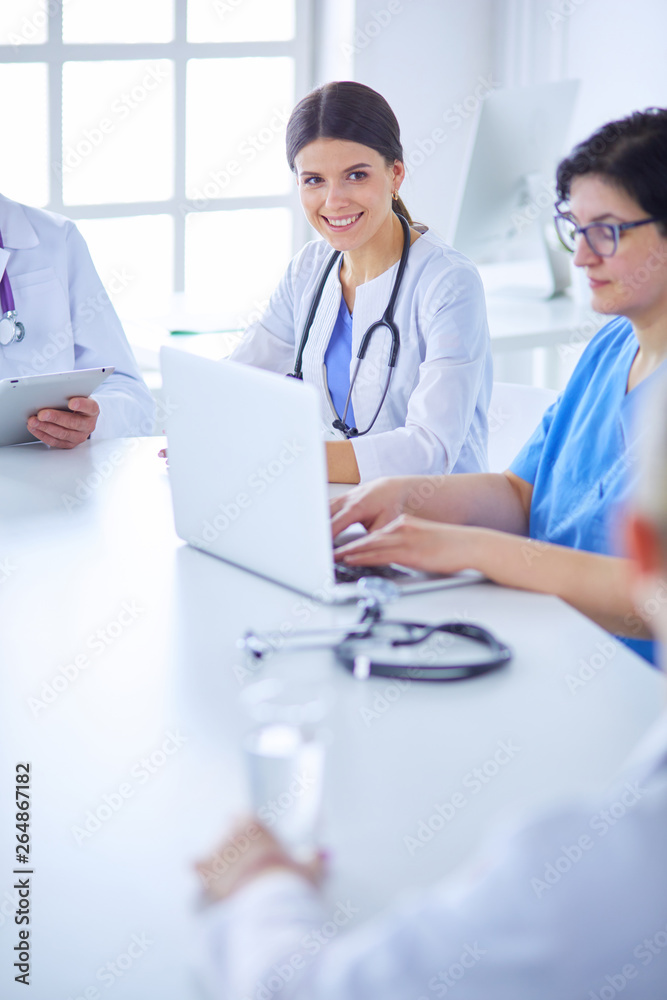 Serious medical team discussing patient's case in a bright office Serious medical team discussing patient's case in a bright office