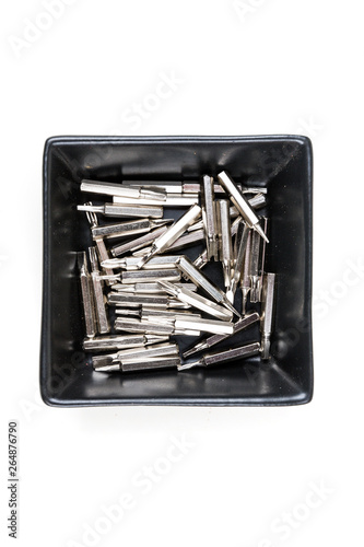 Black bowl ofmetal interchangeable screwdriver bits for a multitool photo