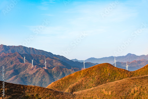 The mountain wind turbines in the sunrise and sunset in the sea of clouds