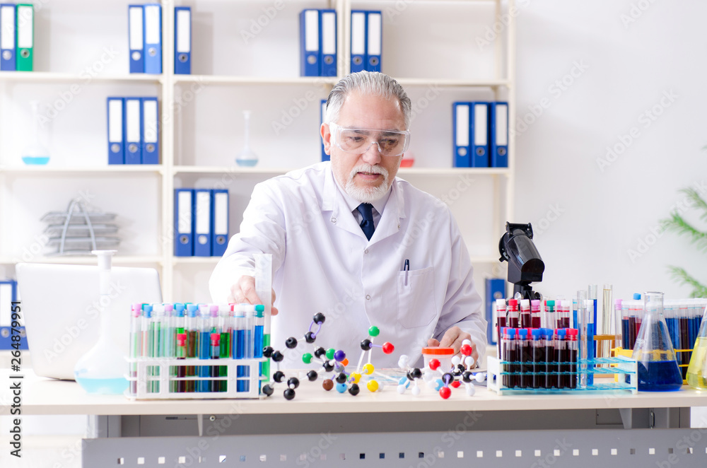 Old male chemist working in the lab Old male chemist working in the lab