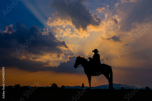 A man in a cowboy outfit with his horse