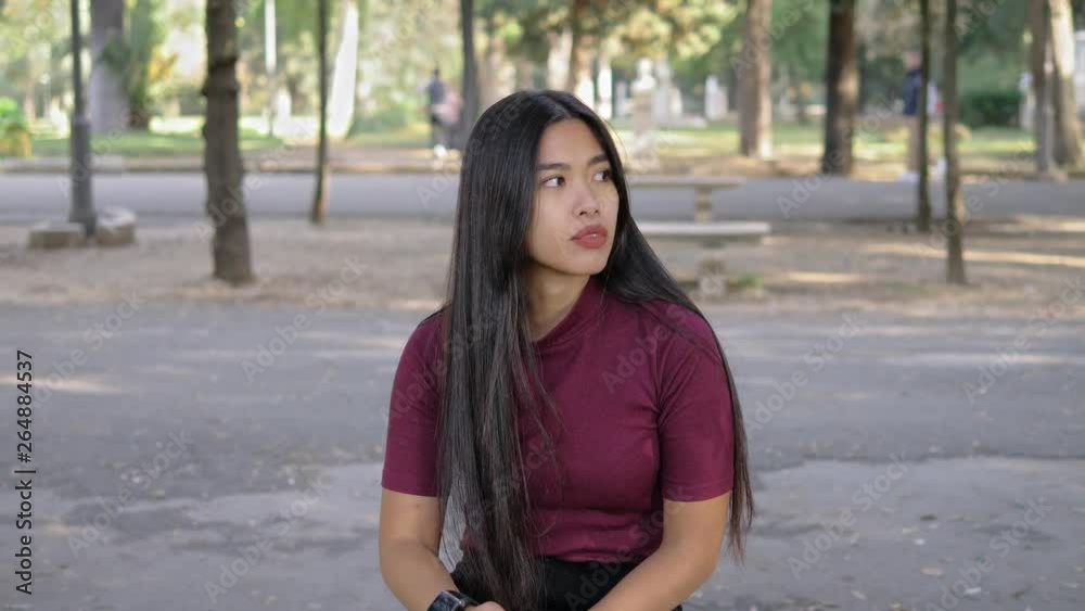 nervous asian woman sitting on bench waiting for someone.waiting, impatience nervous asian woman sitting on bench waiting for someone.waiting, impatience