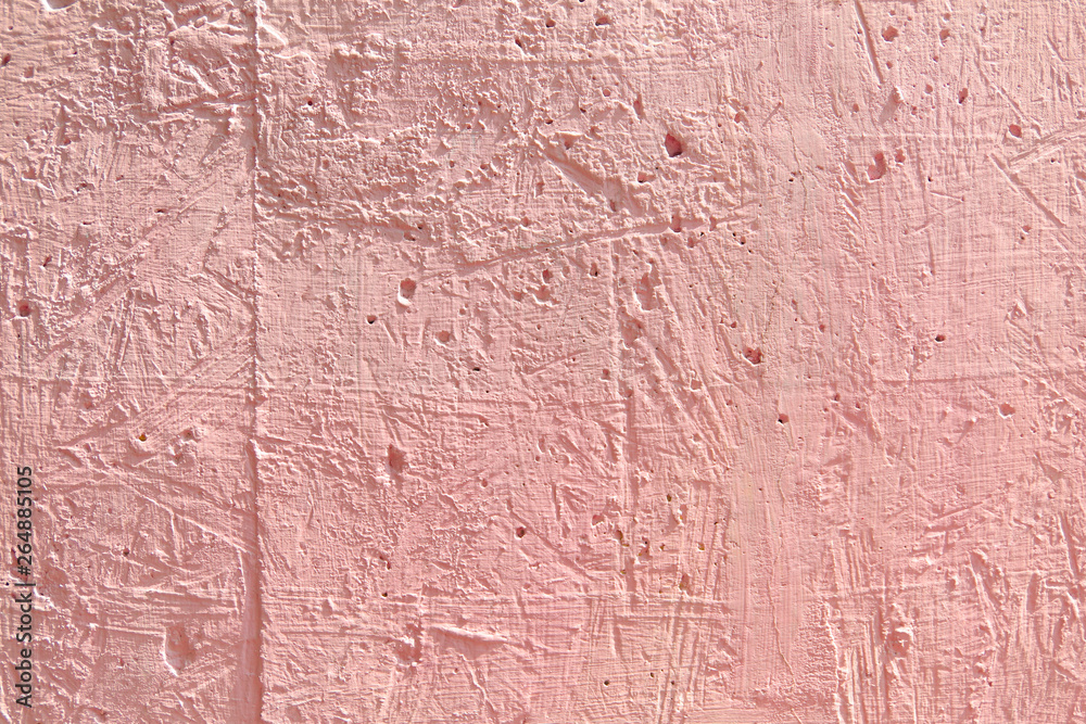 Blurred abstract background. The texture of the painted concrete rough surface with cracks and holes of a delicate pink color. Cropped shot, horizontal, place for text, nobody. The concept of repair 