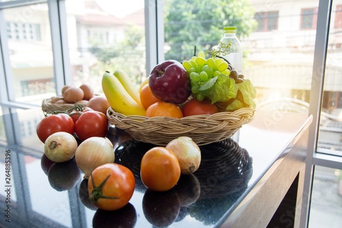 Obraz na plátne Basket of fruit preparing before breakfast put by side of window before cooking