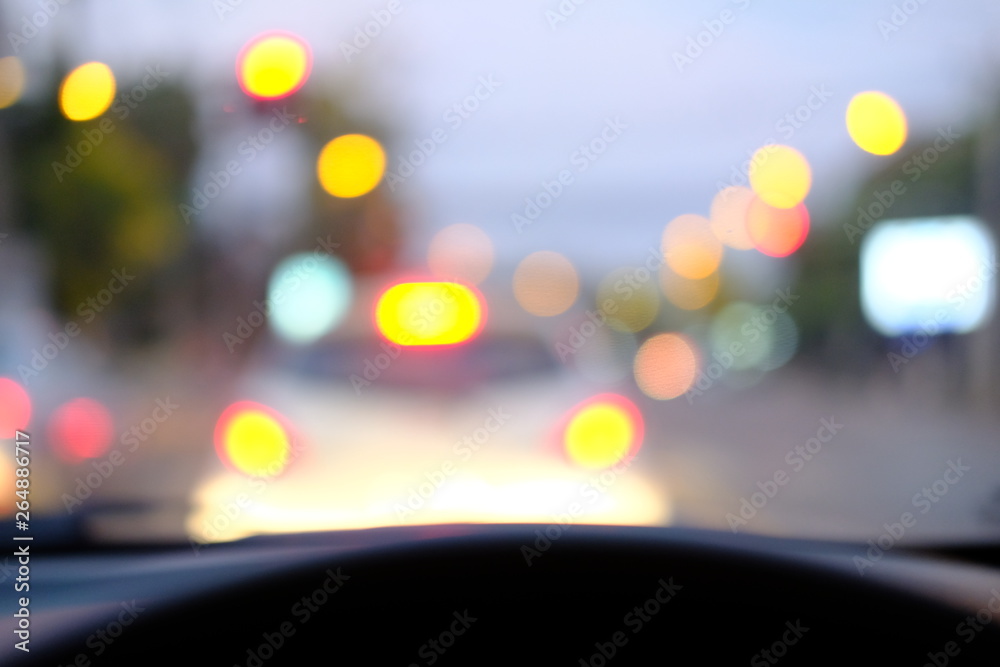 blurred car on street with lots of light spots background