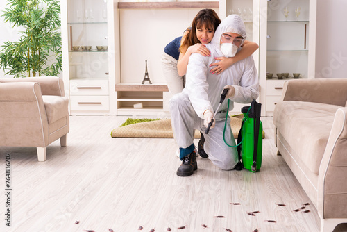 Young professional contractor doing pest control at flat 