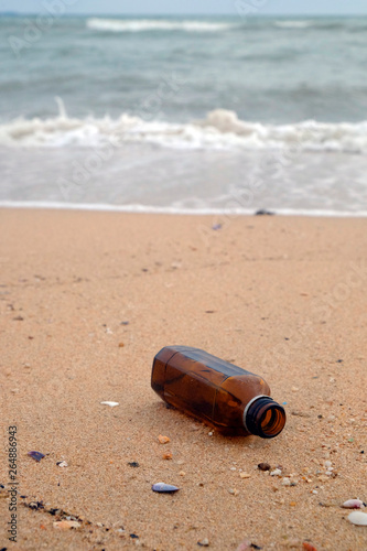 Bottle is on the sand beach  garbage pollution