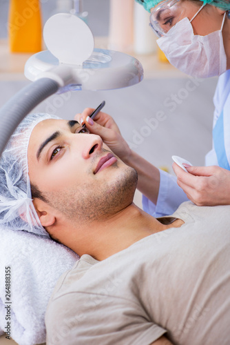 Young handsome man visiting female doctor cosmetologist