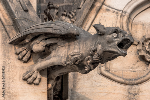 Prague / Czech Republic 03.31.2019: Gargoyle on top of the tower of Church, A gargoyle is a projecting stone waterspout which was often used in Gothic architecture.