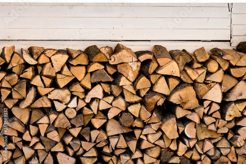Wooden logs  beams  frame. A lot of wood. Wooden log wooden background. Fuel. Harvesting firewood for the winter. Logging