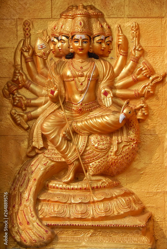 wall art of Indian Hindu Goddess Durga with weapons to end evil ,sit on peacock,in blessing pose in a temple