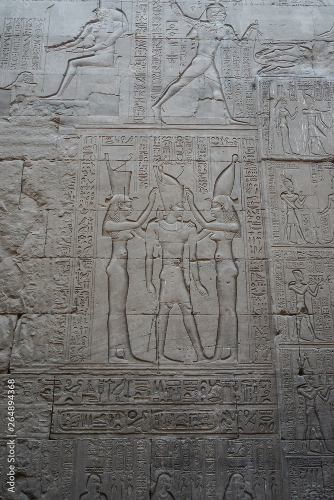 Edfu, Egypt: Detail of wall with carvings at the temple of Edfu, the largest temple dedicated to Horus and Hathor of Dendera. Edfu, Egypt: Detail of wall with carvings at the temple of Edfu, the largest temple dedicated to Horus and Hathor of Dendera.