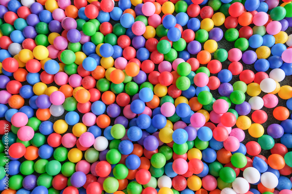 Top view of many colorful balls in ball pool at indoors playground Top view of many colorful balls in ball pool at indoors playground