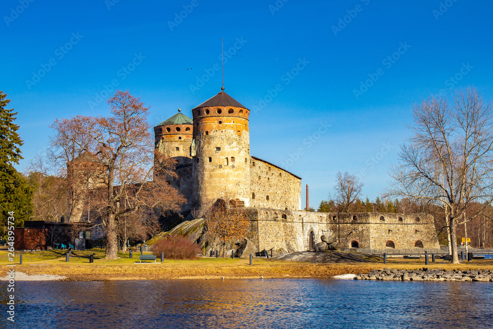 Beautiful view of Olavinlinna, Olofsborg ancient fortress, the 15th-century medieval three - tower castle located in Savonlinna city on a sunny May day. lake Saimaa, Finland.