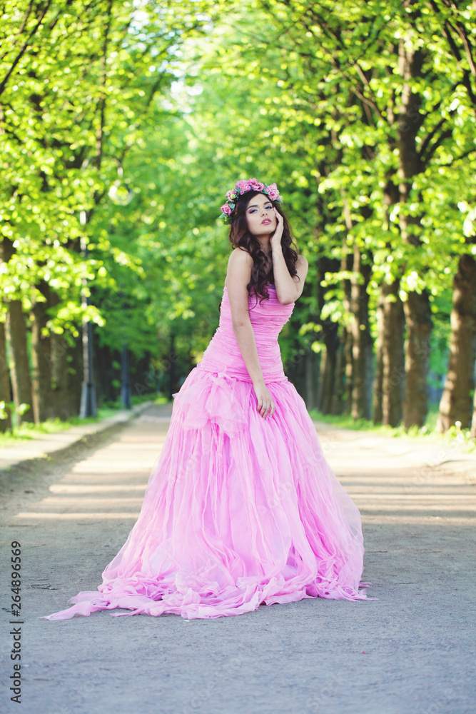 Beautiful woman in pink dress in park Beautiful woman in pink dress in park