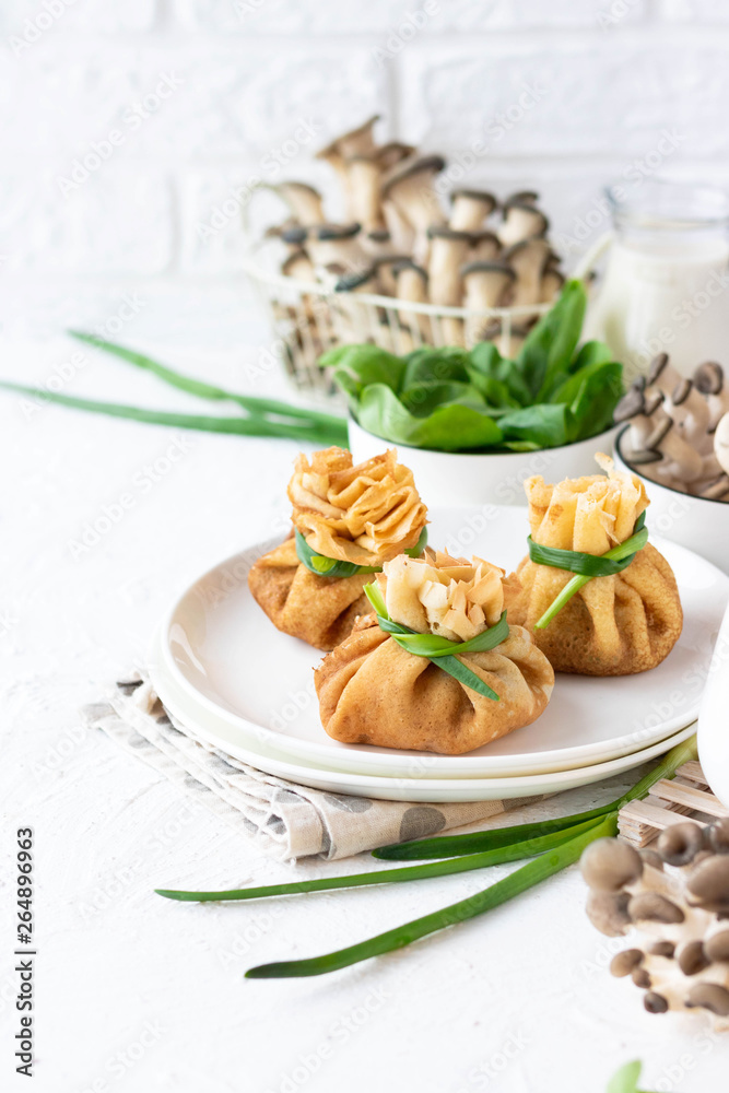 Pancake bags stuffed with with fried oyster mushrooms with spinach Pancake bags stuffed with with fried oyster mushrooms with spinach