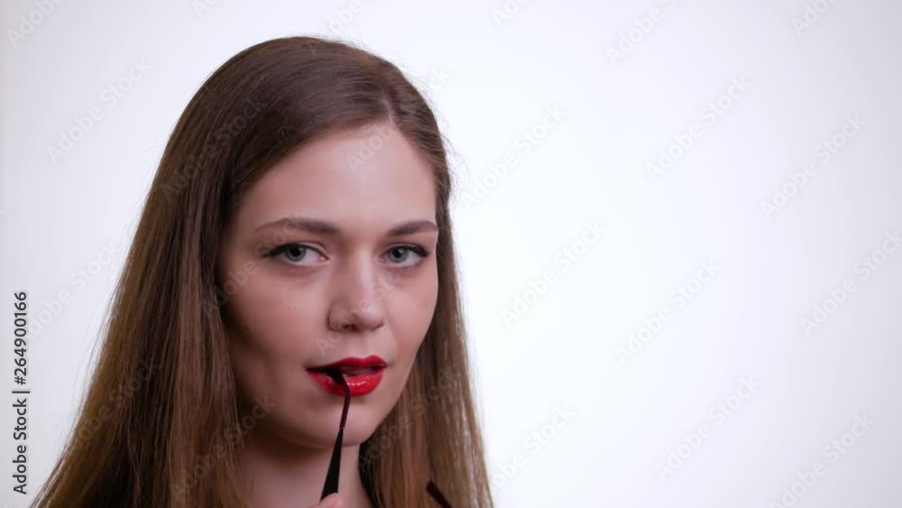Young attractive brunette woman takes off her glasses and looking at camera on a white background. Young attractive brunette woman takes off her glasses and looking at camera on a white background.