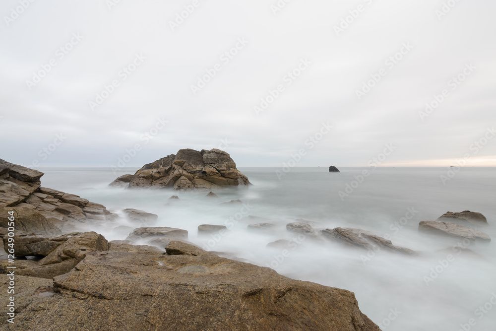 Longexposure of big Rock in the Atlantic Ocean at high tide, France, Brittany, Finistere