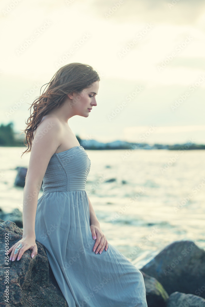 Perfect brunette woman relaxing on ocean coast Perfect brunette woman relaxing on ocean coast