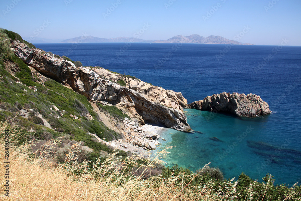 island of Greece. The island of Ikaria in the Aegean sea. Turquoise, blue sea. Rocky shore. Tourism and travel around the world.