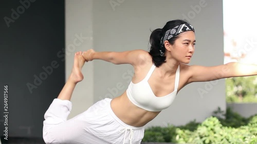 beautigul asian girl yoga and stretching outdoor with background city and swimming pool