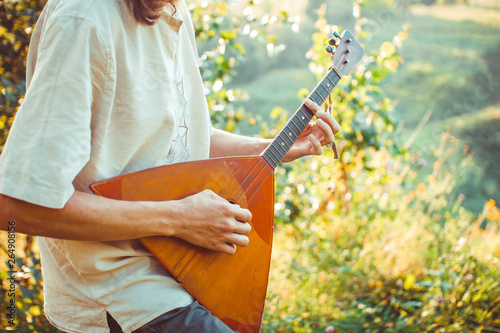 man playing the balalaika photo