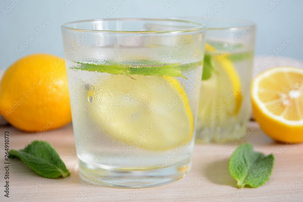 Cold refreshing lemonade with fresh mint and lemon in a glass Summer drink Cold refreshing lemonade with fresh mint and lemon in a glass Summer drink