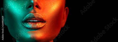 Obraz na plátně Fashion model woman face in bright sparkles, colorful neon lights, beautiful sexy girl lips
