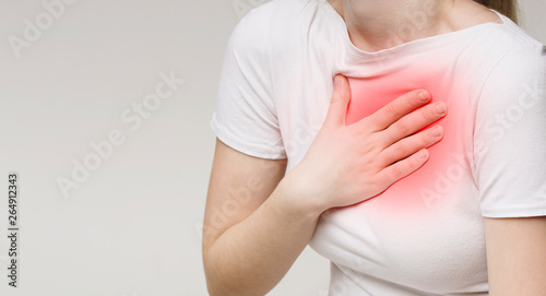 Woman suffering from acid reflux or heartburn photo