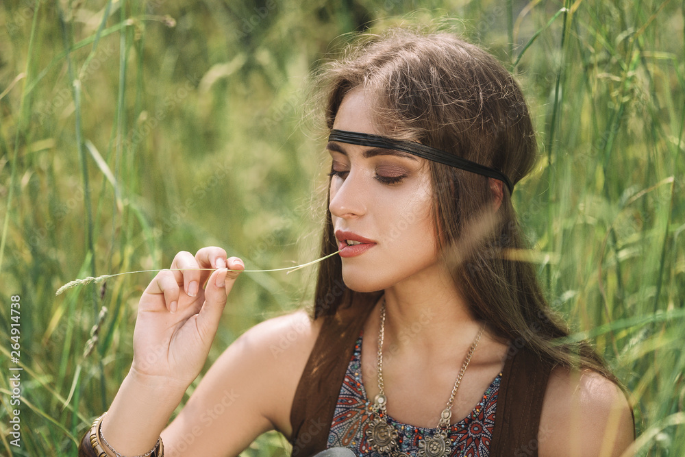 portrait of beautiful hippie girl sitting on grass portrait of beautiful hippie girl sitting on grass