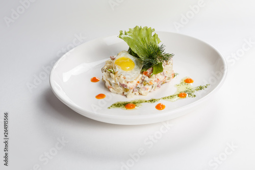 Food on white plate. Side dish. Salad. Greenery. Egg.