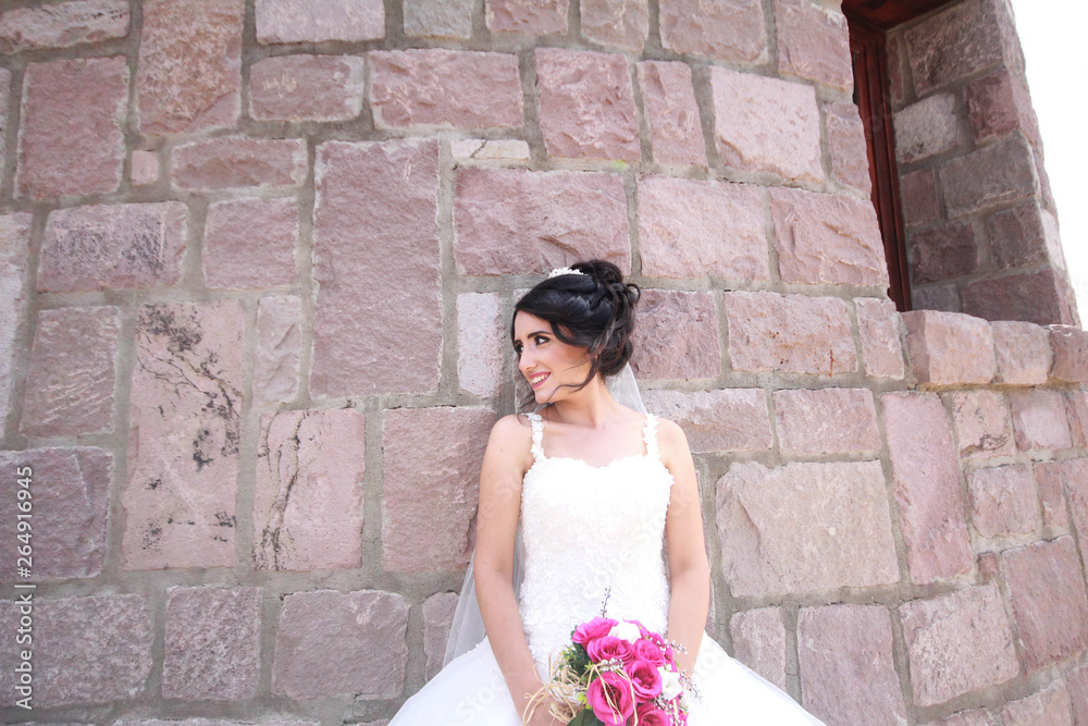 bride posing near a stone windmill. love and wedding concept 