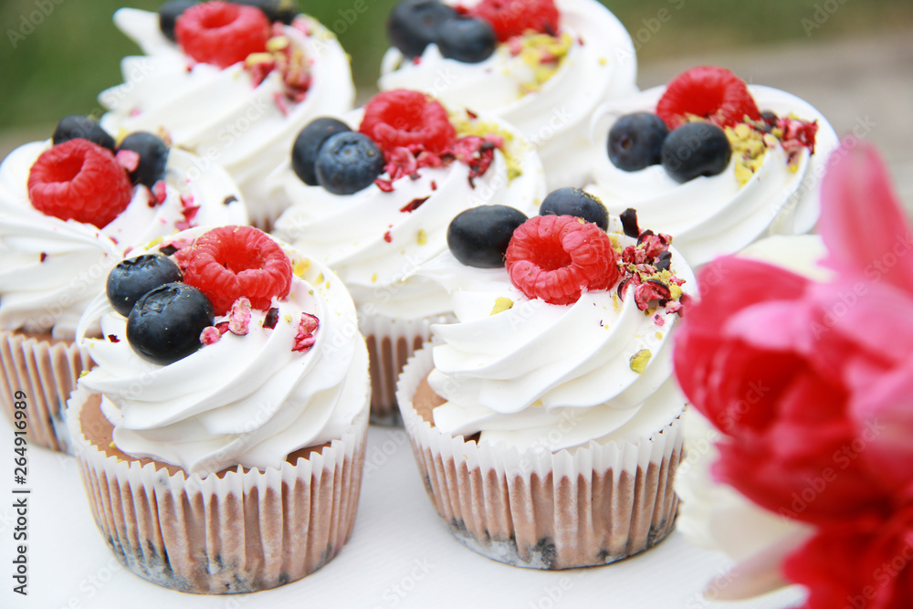 Homemade pavlovas cupcakes with berries and tulips Homemade pavlovas cupcakes with berries and tulips