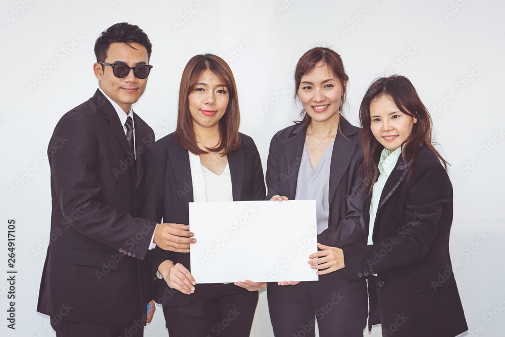 Group of business people posing with white board Group of business people posing with white board