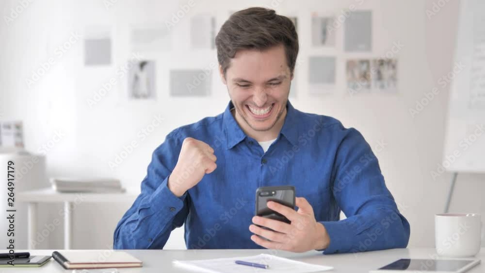 Casual Adult Man Celebrating Success on Smartphone