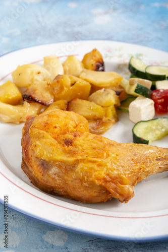 Fried Chicken Leg With Potatoes And Greece Salad On The Plate © zlajaphoto