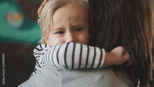 mother holding a baby in her arms. mother comforts daughter