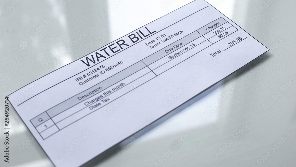 Water bill lying on table, payment for services, month expenses, tariff close up