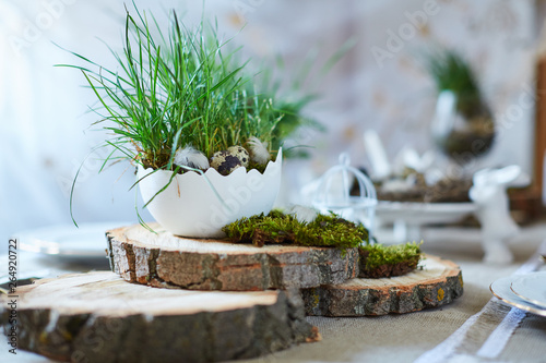 Easter table set. Decorated with eggs, nests and flowers.