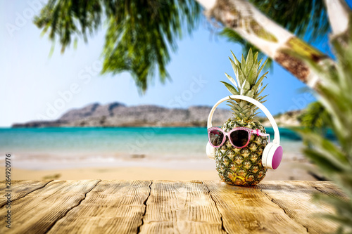 Fresh fruits on pineapple and summer time on beach 