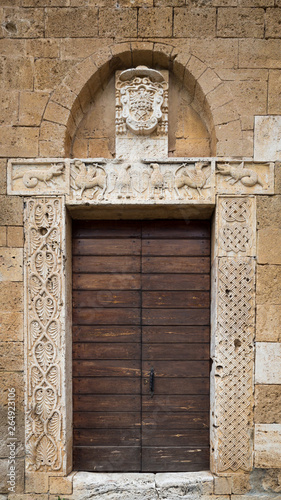 The carved stone entrance of an ancient Italian medieval church.
