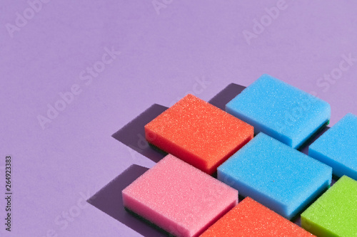 Colorful sponges isolated on blue background.close up photo. copy space.