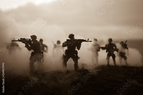 War Concept. Military silhouettes fighting scene on war fog sky background, World War Soldiers Silhouettes Below Cloudy Skyline At night. Attack scene. Armored vehicles. Tanks battle. Decoration