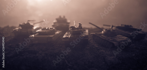 War Concept. Military silhouettes fighting scene on war fog sky background, World War Soldiers Silhouettes Below Cloudy Skyline at sunset. Attack scene. Armored vehicles.