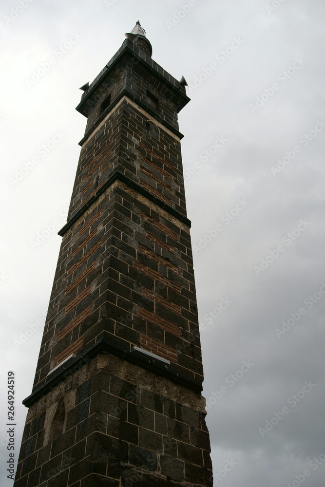 Close up view of minaret with four foots in Diyarbakir in a cloudy day