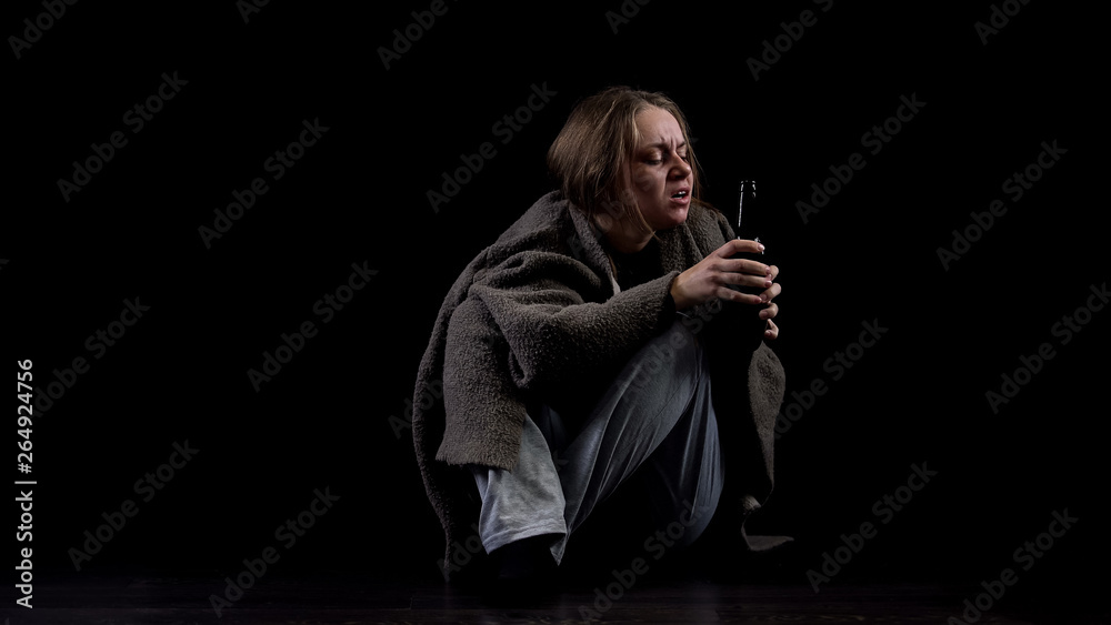 Alcoholic woman greedily drinking beer from bottle, harmful addiction, abuse Alcoholic woman greedily drinking beer from bottle, harmful addiction, abuse