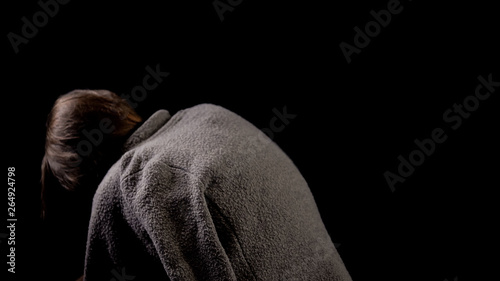 Photography Hunchback beggar on black background, spinal diseases in old age, kyphosis