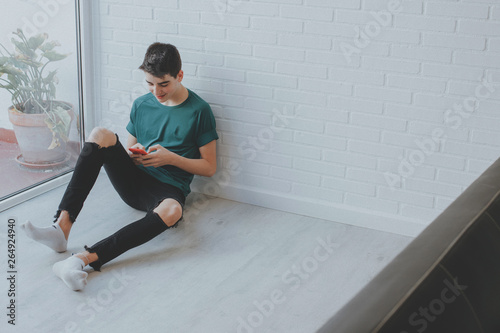 young or teen at home with mobile phone