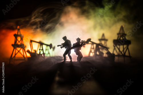 Silhouette of military soldier or officer with weapons. shot, holding gun, colorful sky, background. war and military concept. © zef art