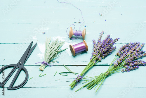lavender bouquet arrangement with modern scissors on blue wooden